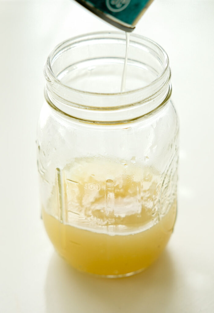 collecting aquafaba (chickpea brine) in a mason jar
